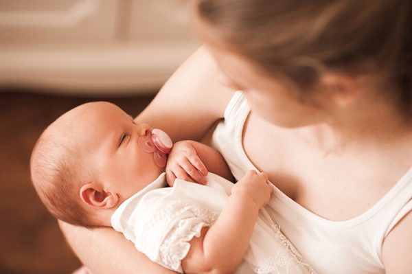 baby with pacifier during the period of purple crying