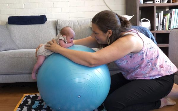 Baby tummy time on an exercise ball to make it easier