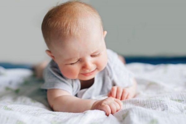baby unhappy on bed