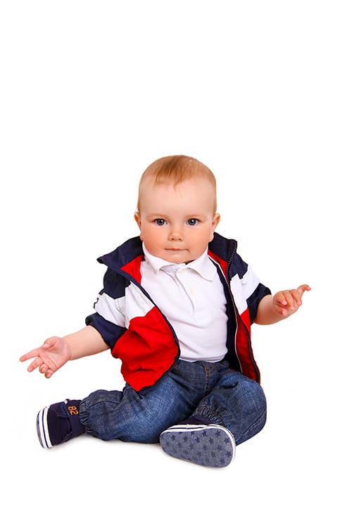 male child side sitting upright with both legs facing one side
