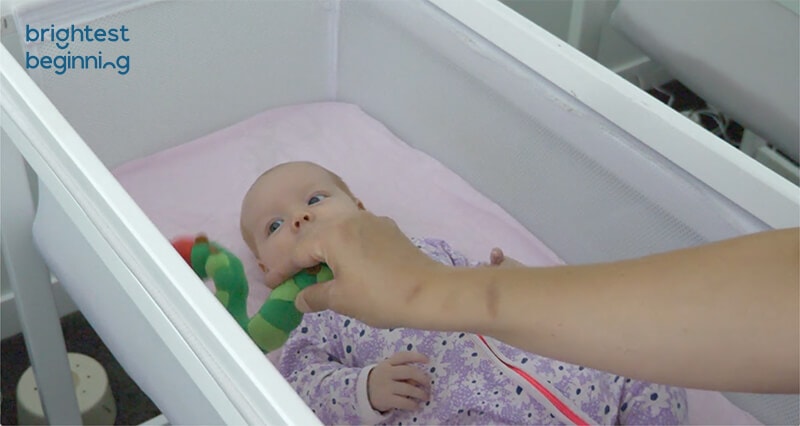 baby looking at same toy but now on the other side of their body as they track with their eyes
