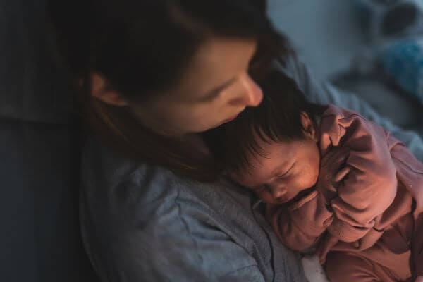 baby asleep on mother's chest
